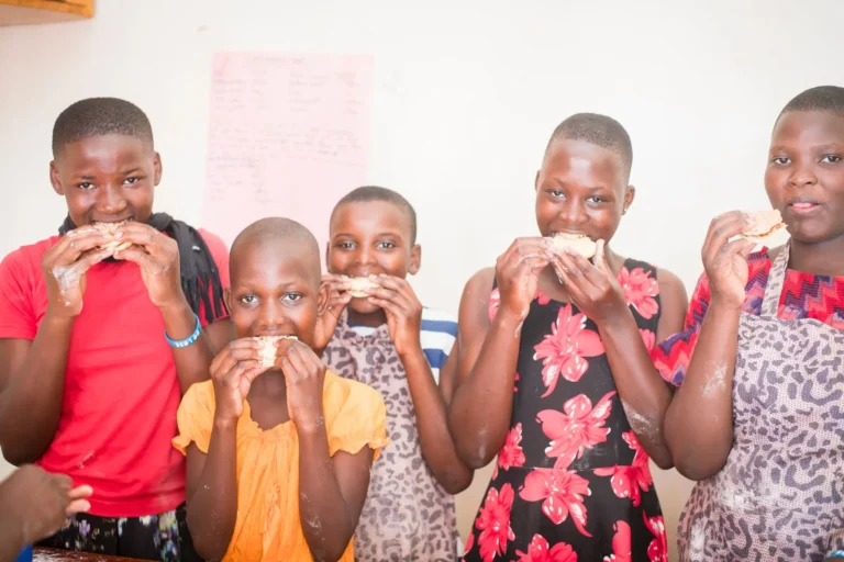 A group of girls tasting what they baked in a baking skills class